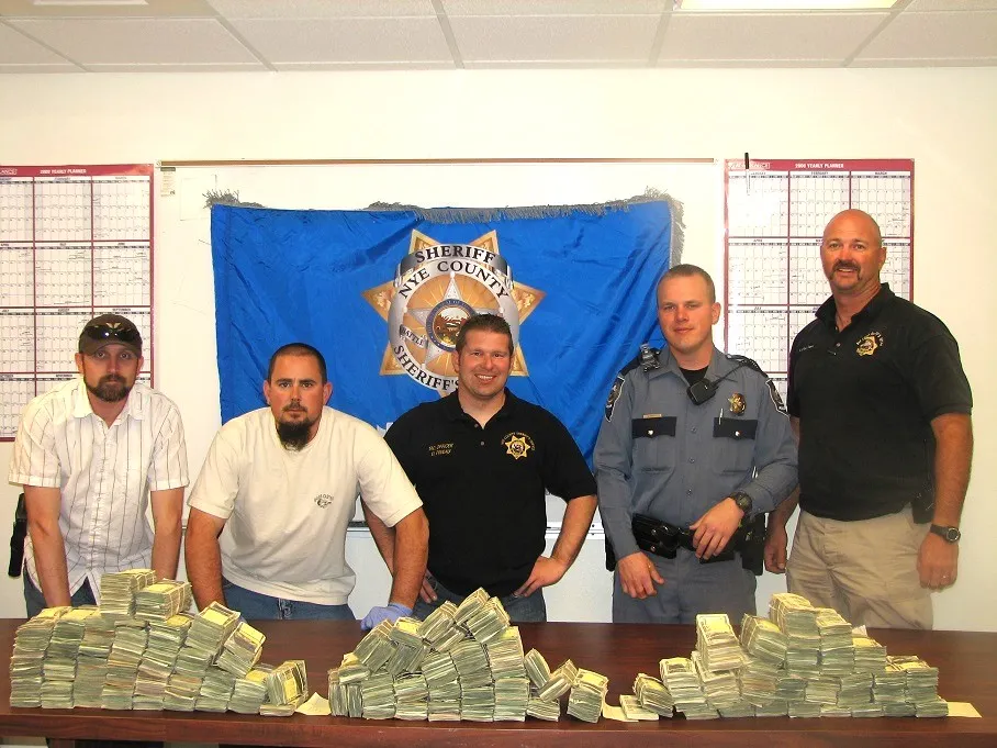 Dan Pineau and fellow deputies with cash recovered in a Nye County narcotics seizure