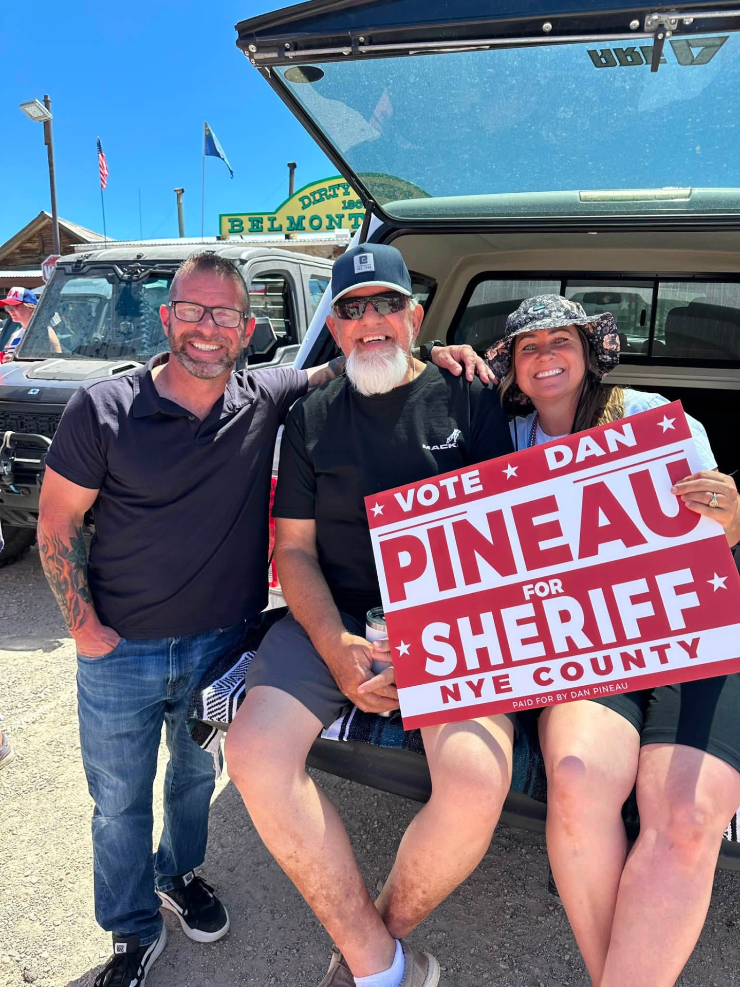 Dan Pineau with supporters holding a Vote Dan Pineau for Sheriff sign